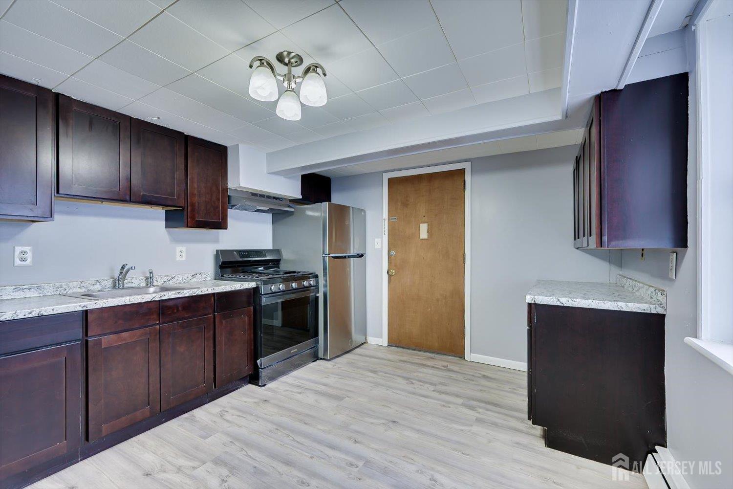 2 Garfield Park Edison, NJ 08837 - Photo 5 of 21 a kitchen with stainless steel appliances granite countertop a stove refrigerator sink and cabinets