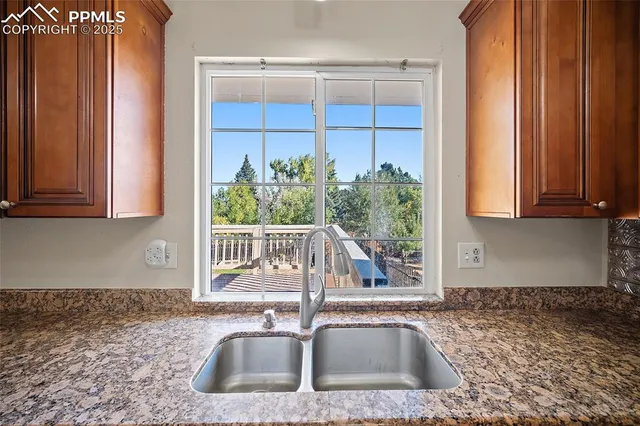 a kitchen with a sink and potted plant