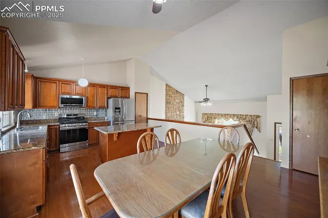 a dining room with furniture and wooden floor