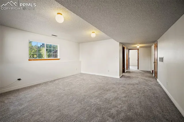 an empty room with windows and closet