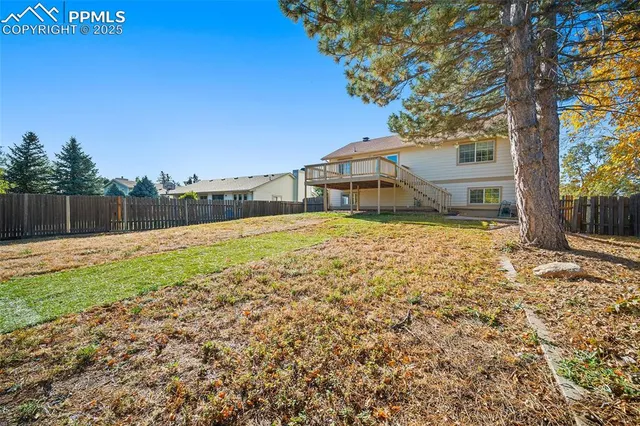a white house that has a tree in front of it
