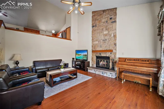 a living room with furniture fireplace and wooden floor