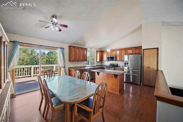 a dining room with furniture a window and wooden floor