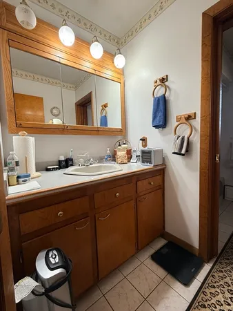 a bathroom with a toilet a sink and a window