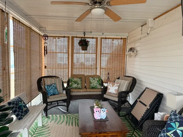 a kitchen with stainless steel appliances a refrigerator a stove top oven a sink a dining table and chairs