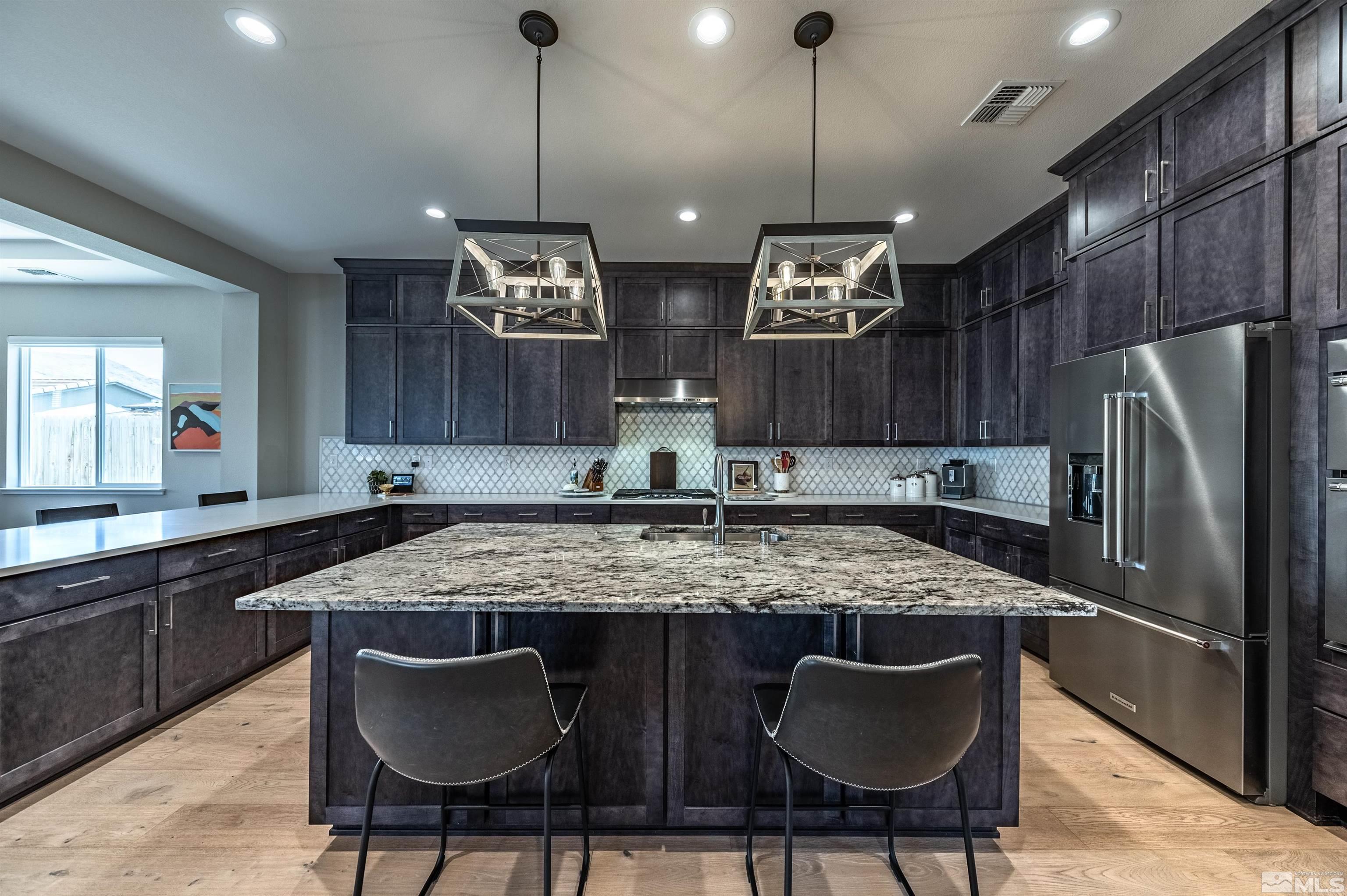 9604 Copperhorn Way Reno, NV 89521 - Photo 11 of 39 a kitchen with stainless steel appliances granite countertop a kitchen island a stove and a refrigerator