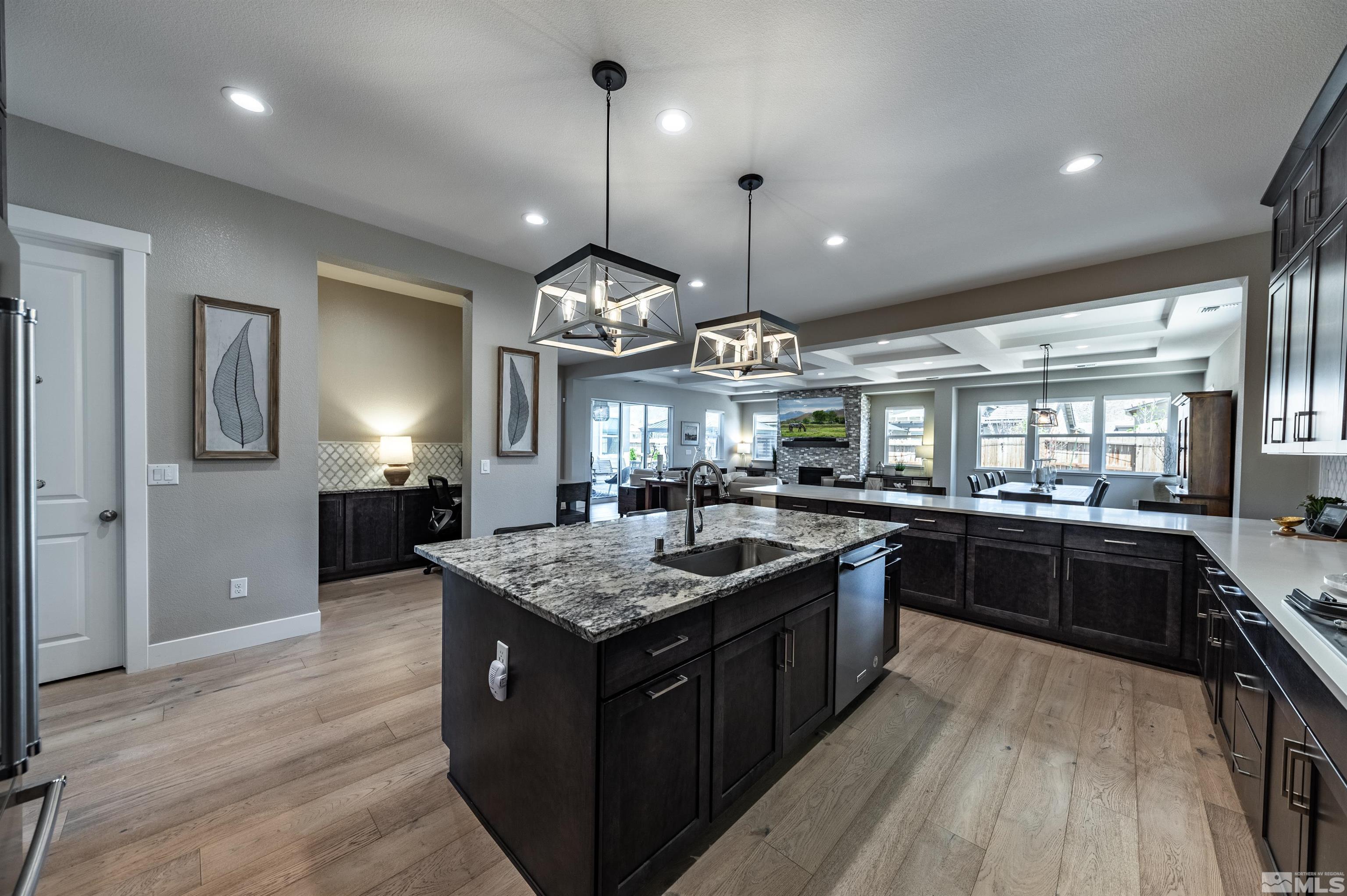 9604 Copperhorn Way Reno, NV 89521 - Photo 12 of 39 a kitchen with a stove center island and wooden floor