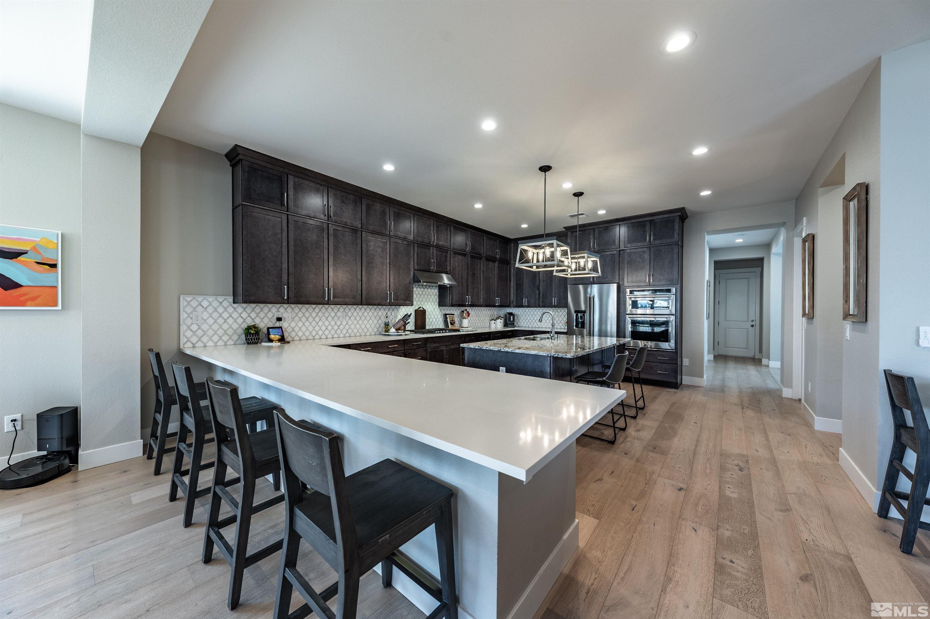 9604 Copperhorn Way Reno, NV 89521 - Photo 14 of 39 a large kitchen with a table and chairs