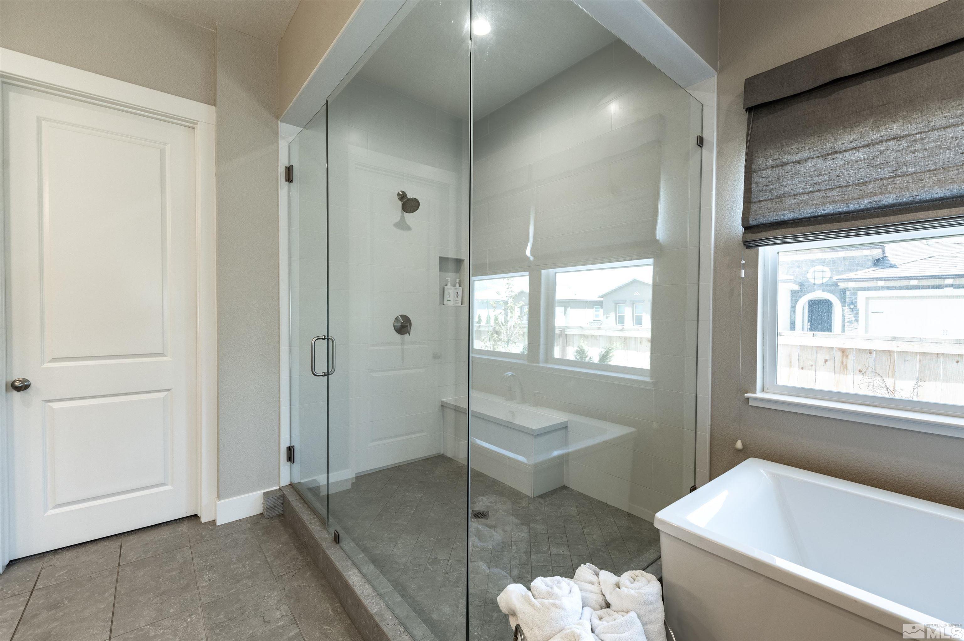 9604 Copperhorn Way Reno, NV 89521 - Photo 20 of 39 a spacious bathroom with a bathtub and shower