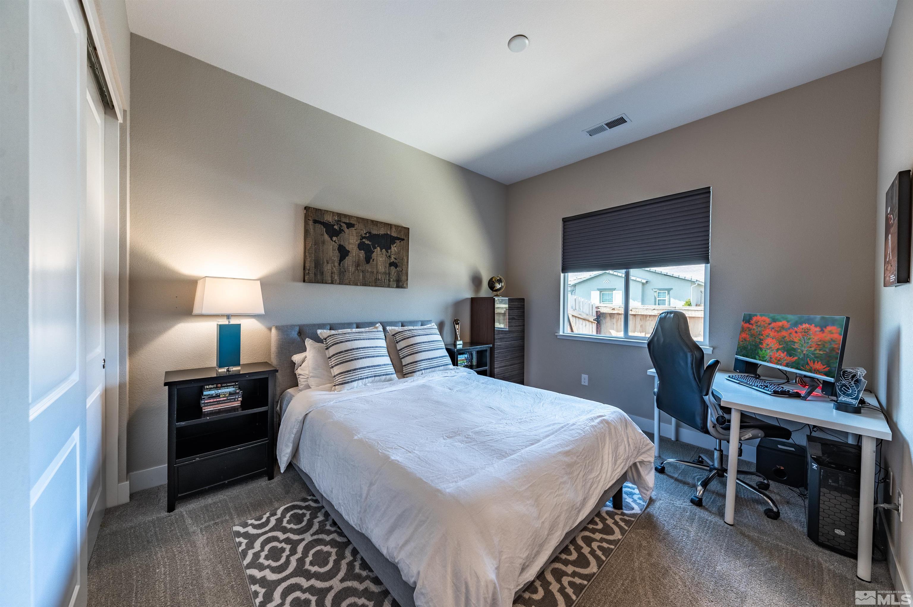 9604 Copperhorn Way Reno, NV 89521 - Photo 23 of 39 a bedroom with a bed and a desk