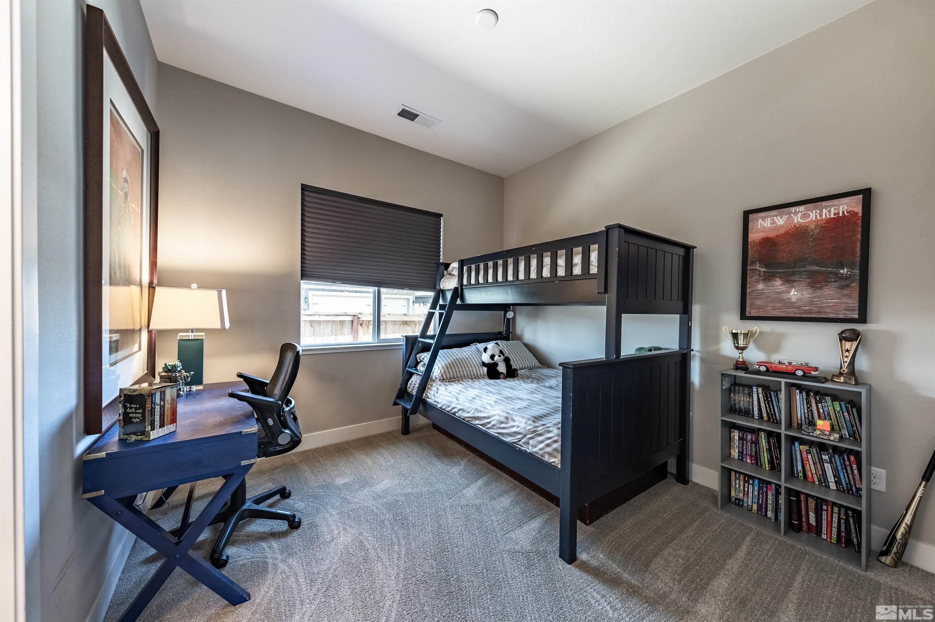 9604 Copperhorn Way Reno, NV 89521 - Photo 26 of 39 a bedroom with furniture and a book shelf