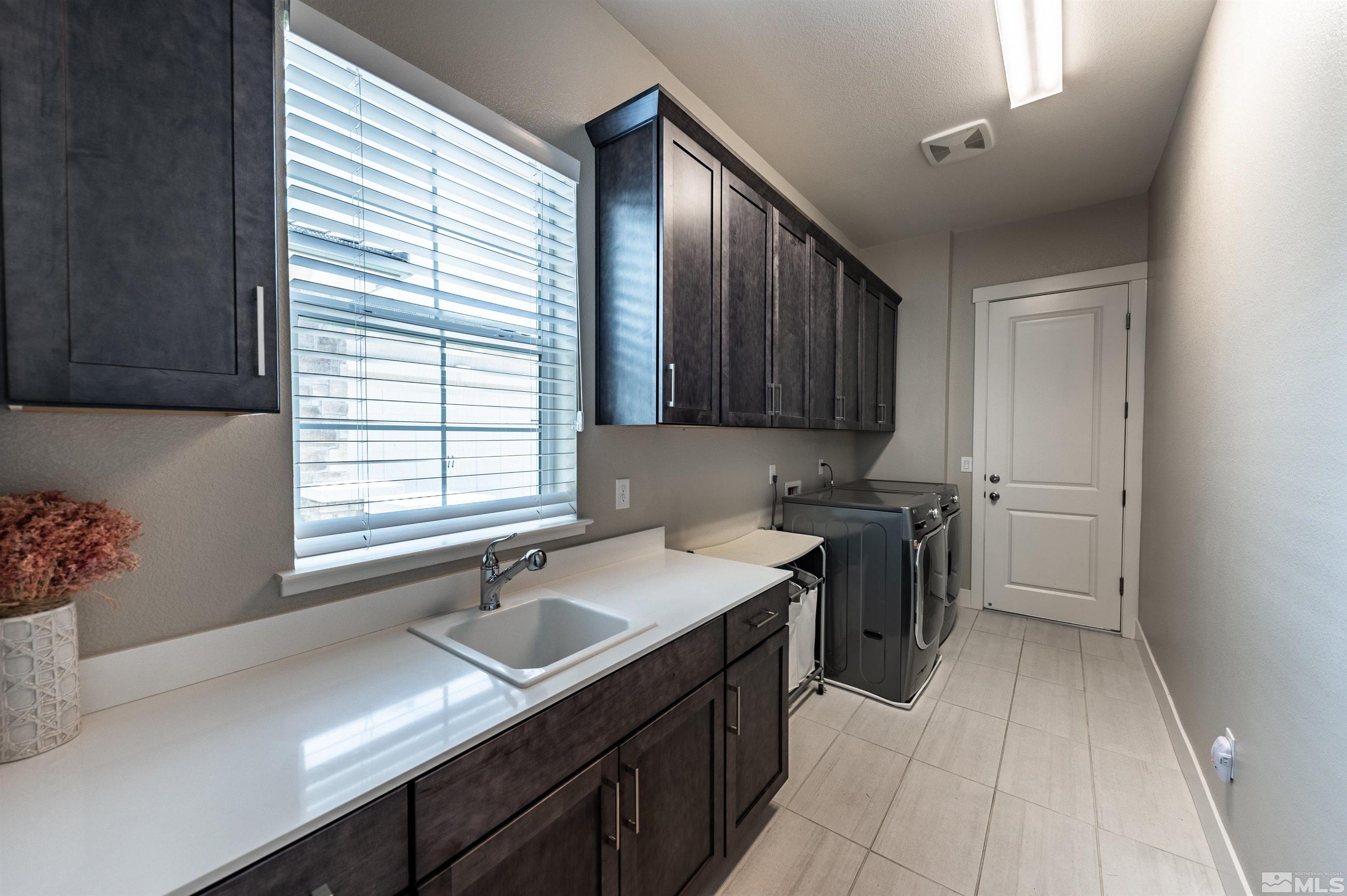 9604 Copperhorn Way Reno, NV 89521 - Photo 30 of 39 a kitchen with a sink cabinets appliances and a window