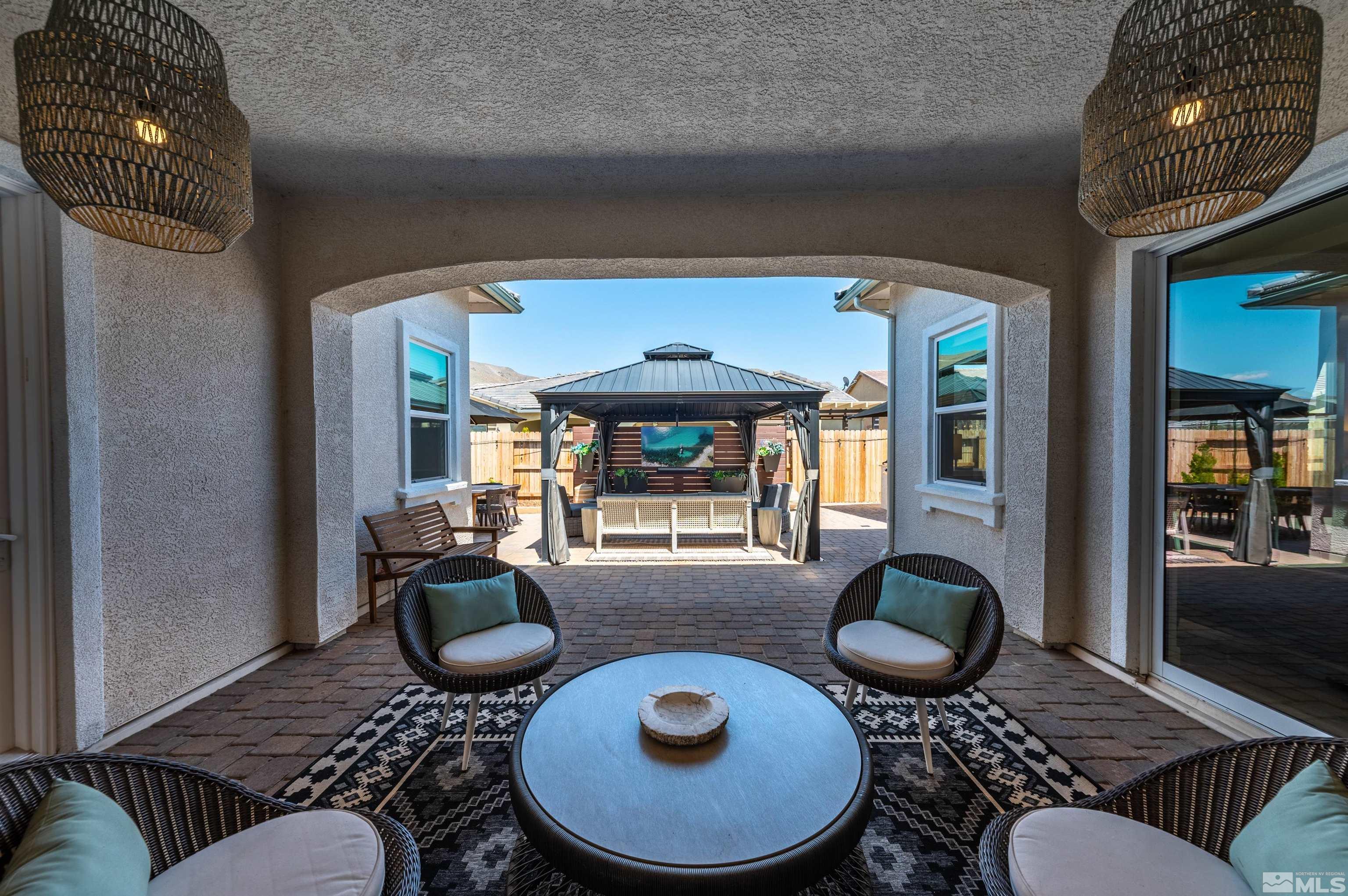 9604 Copperhorn Way Reno, NV 89521 - Photo 33 of 39 a living room with furniture a rug and a window