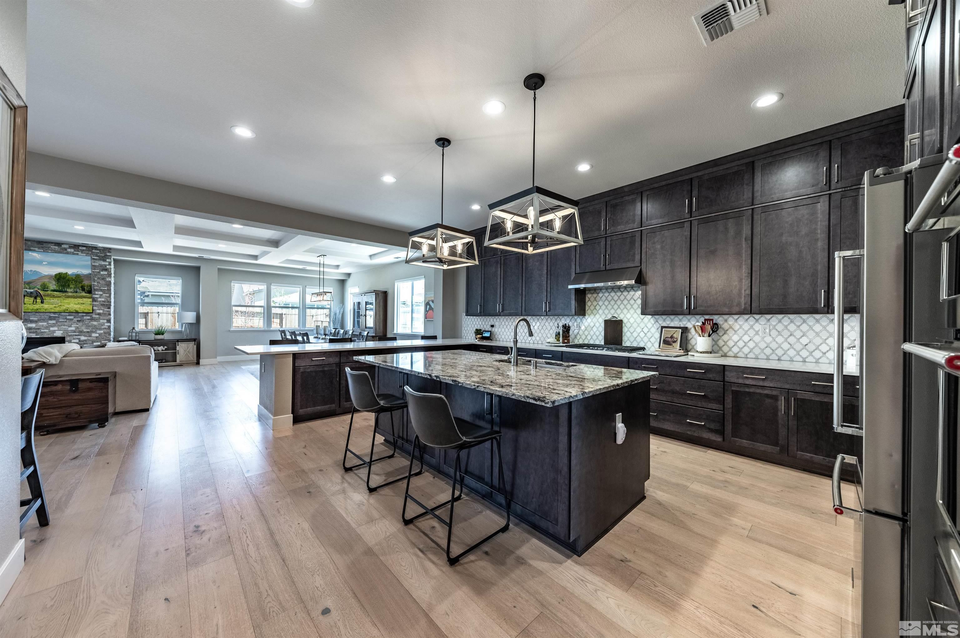 9604 Copperhorn Way Reno, NV 89521 - Photo 8 of 39 a large kitchen with lots of counter space a sink appliances and a dining table