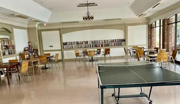 a large dining space with furniture window and wooden floor
