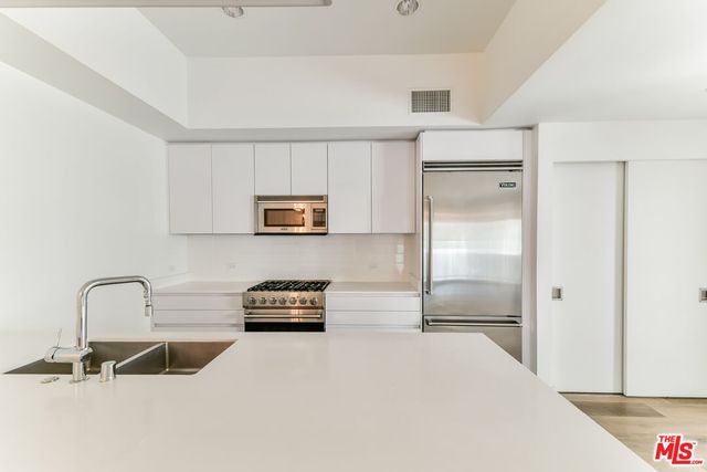 a kitchen with stainless steel appliances granite countertop a stove and a microwave