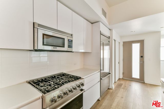 a view of a room with wooden floor and windows