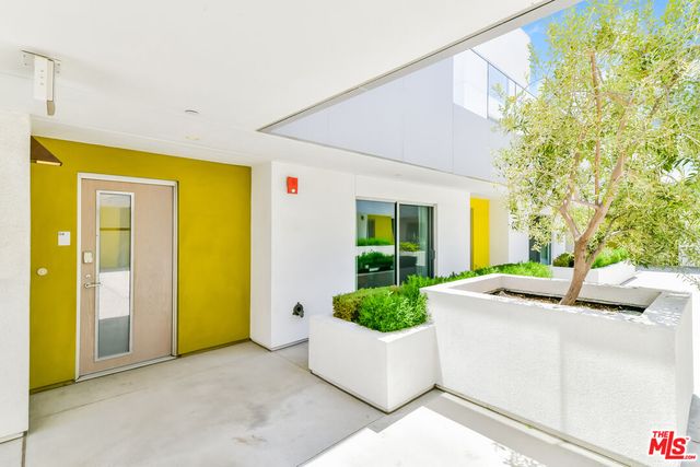 a view of a patio with couches and table and chairs with wooden fence