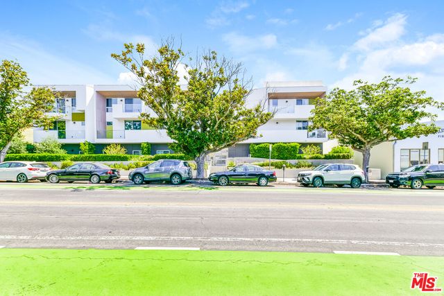a front view of a house with trees