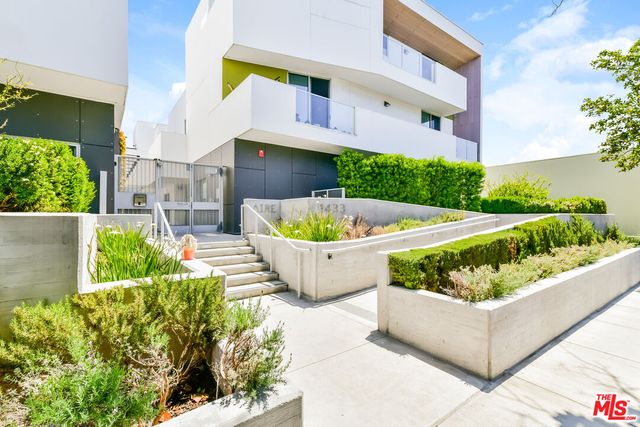 a kitchen with a refrigerator and a stove top oven