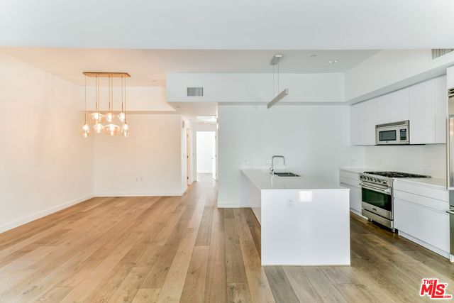 a kitchen with a refrigerator and a stove