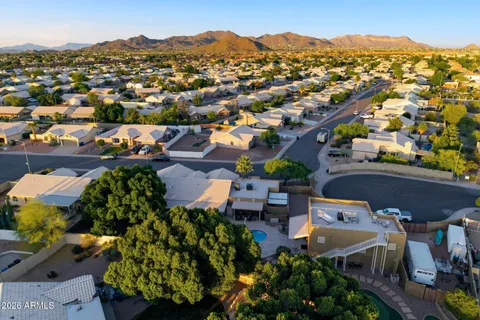 an aerial view of a house with a yard and garden