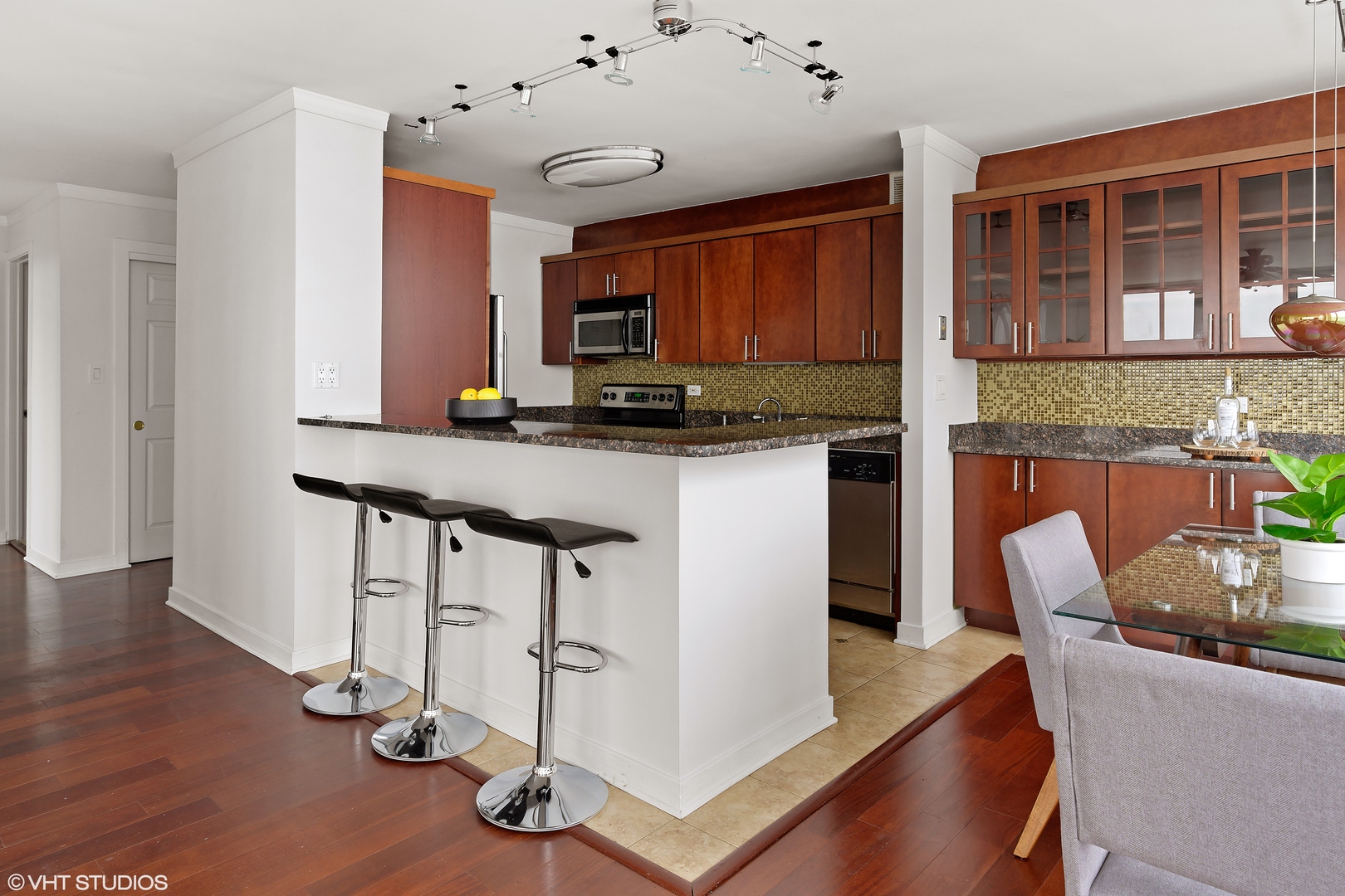 655 West Irving Park Road, Unit 5301 Chicago, IL 60613 - Photo 7 of 20 a kitchen with granite countertop a stove a sink and a refrigerator