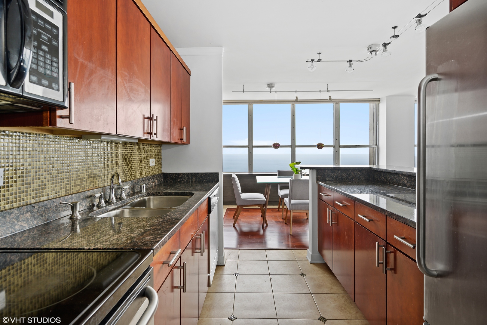 655 West Irving Park Road, Unit 5301 Chicago, IL 60613 - Photo 8 of 20 a kitchen with stainless steel appliances granite countertop a sink stove and cabinets