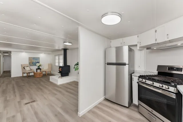 a kitchen with refrigerator and cabinets