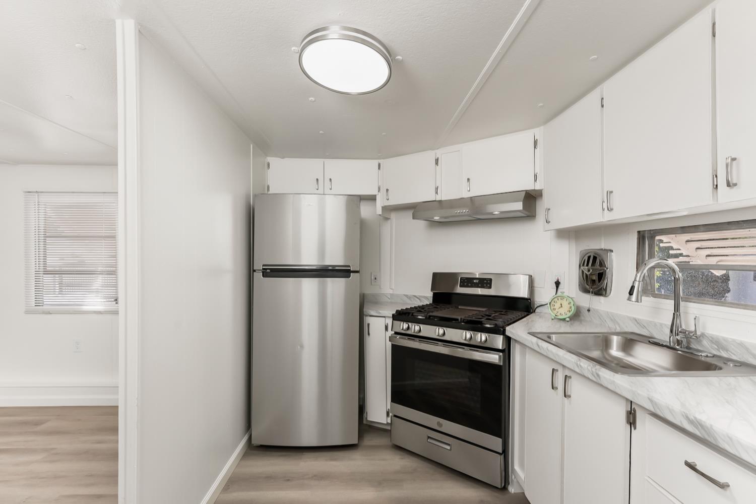 1525 Cold Springs Road, Unit 48 Placerville, CA 95667 - Photo 12 of 44 a kitchen with cabinets stainless steel appliances and a sink