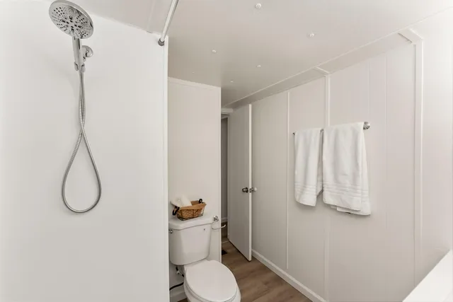 a bathroom with a shower toilet and sink
