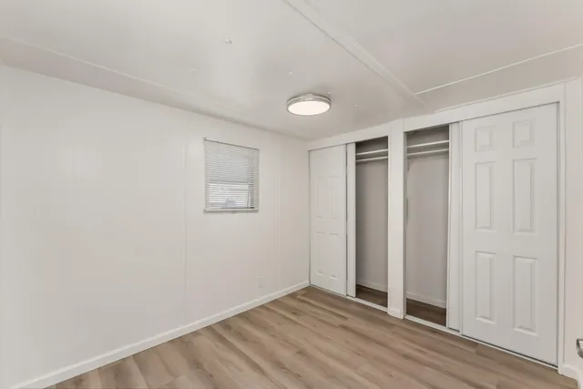 an empty room with wooden floor