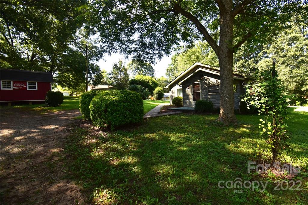 210 Proctor Street Lincolnton, NC 28092 - Photo 18 of 19 a view of a house with a tree in a yard