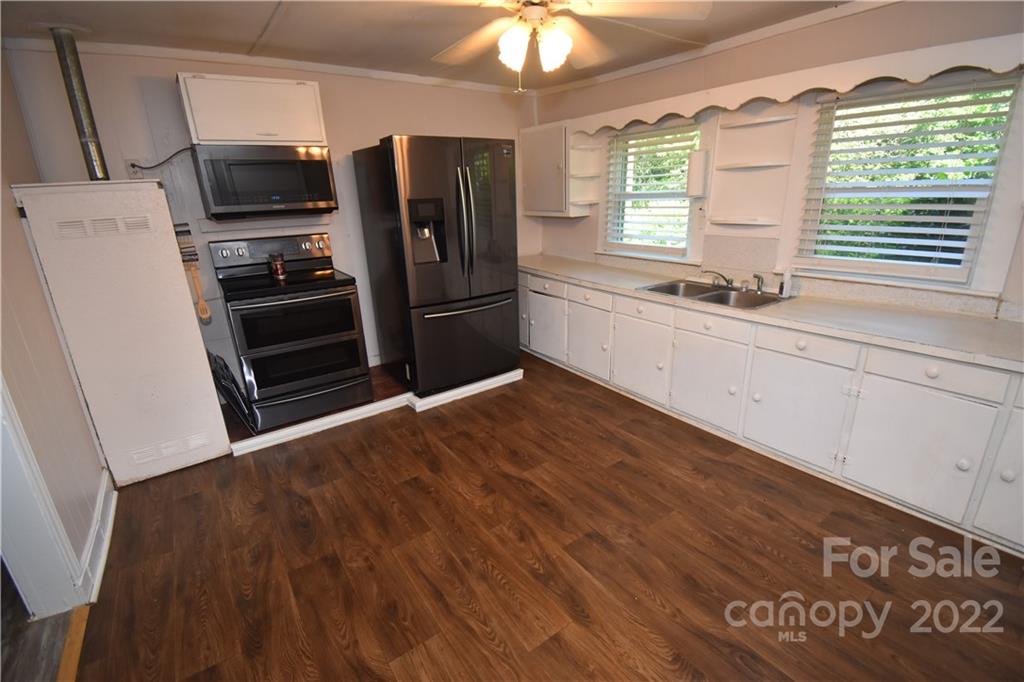 210 Proctor Street Lincolnton, NC 28092 - Photo 6 of 19 a kitchen with granite countertop a refrigerator and a sink