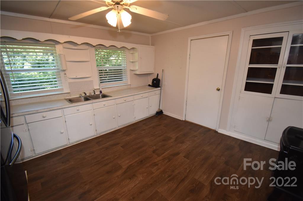 210 Proctor Street Lincolnton, NC 28092 - Photo 7 of 19 a kitchen with granite countertop a stove a sink and a microwave