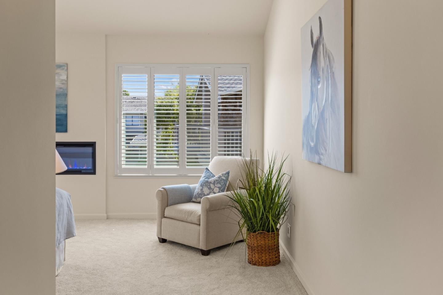 3850 Rio Road, Unit 61 Carmel, CA 93923 - Photo 12 of 46 a living room with furniture and a potted plant
