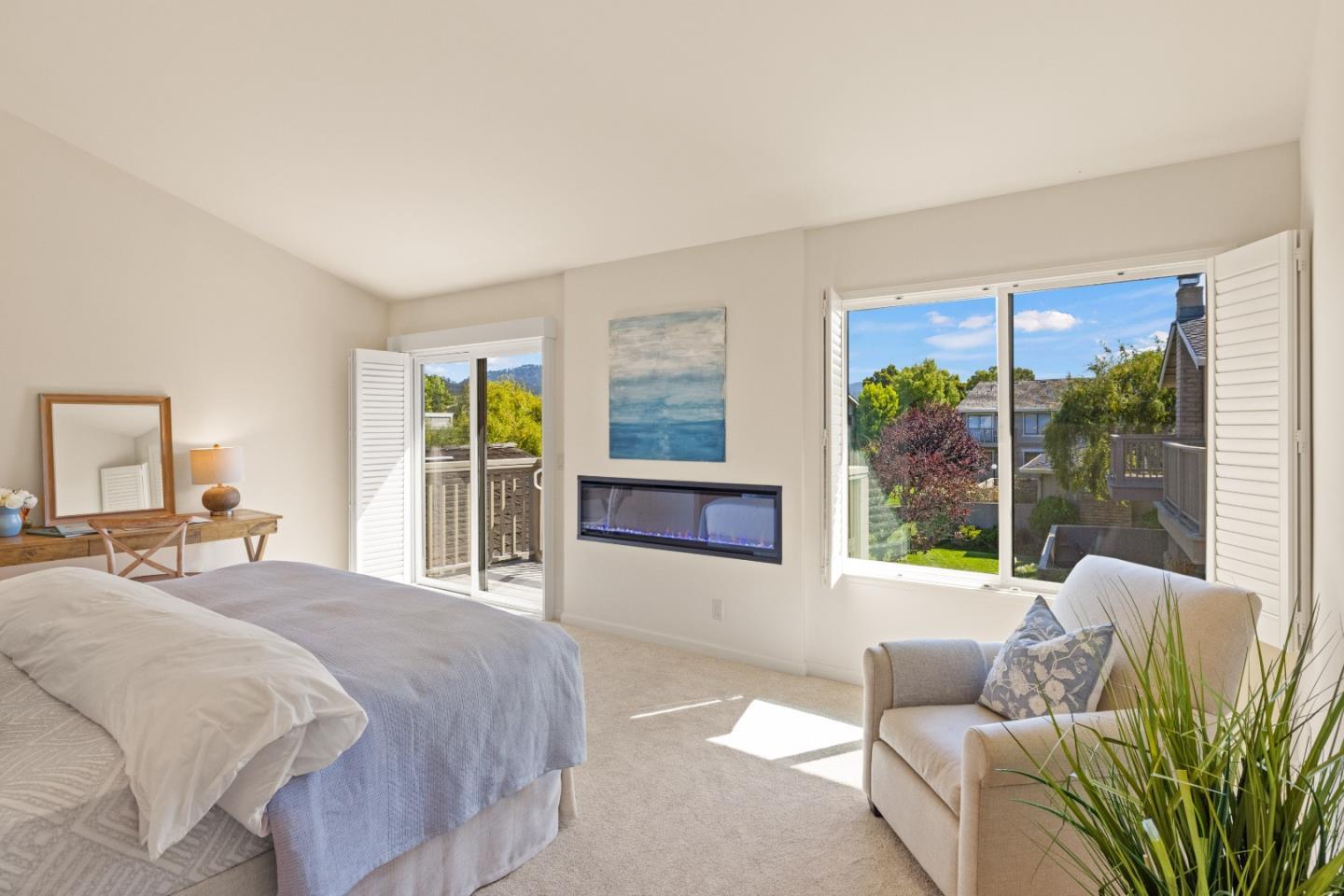 3850 Rio Road, Unit 61 Carmel, CA 93923 - Photo 13 of 46 a spacious bedroom with a bed and glass window