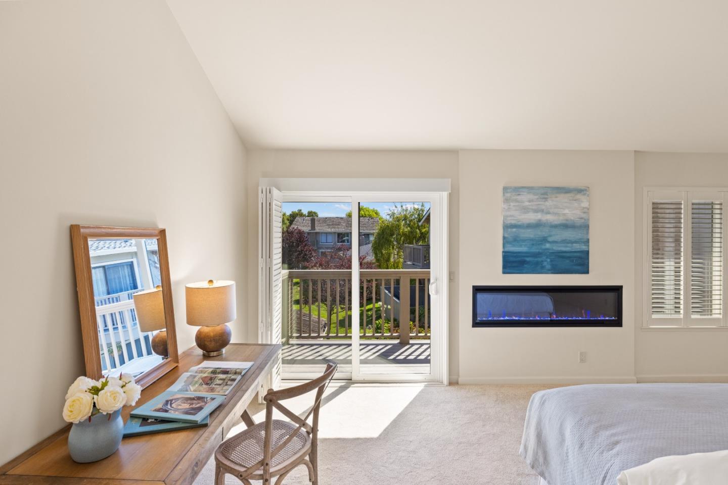 3850 Rio Road, Unit 61 Carmel, CA 93923 - Photo 16 of 46 a bedroom with a bed and glass window