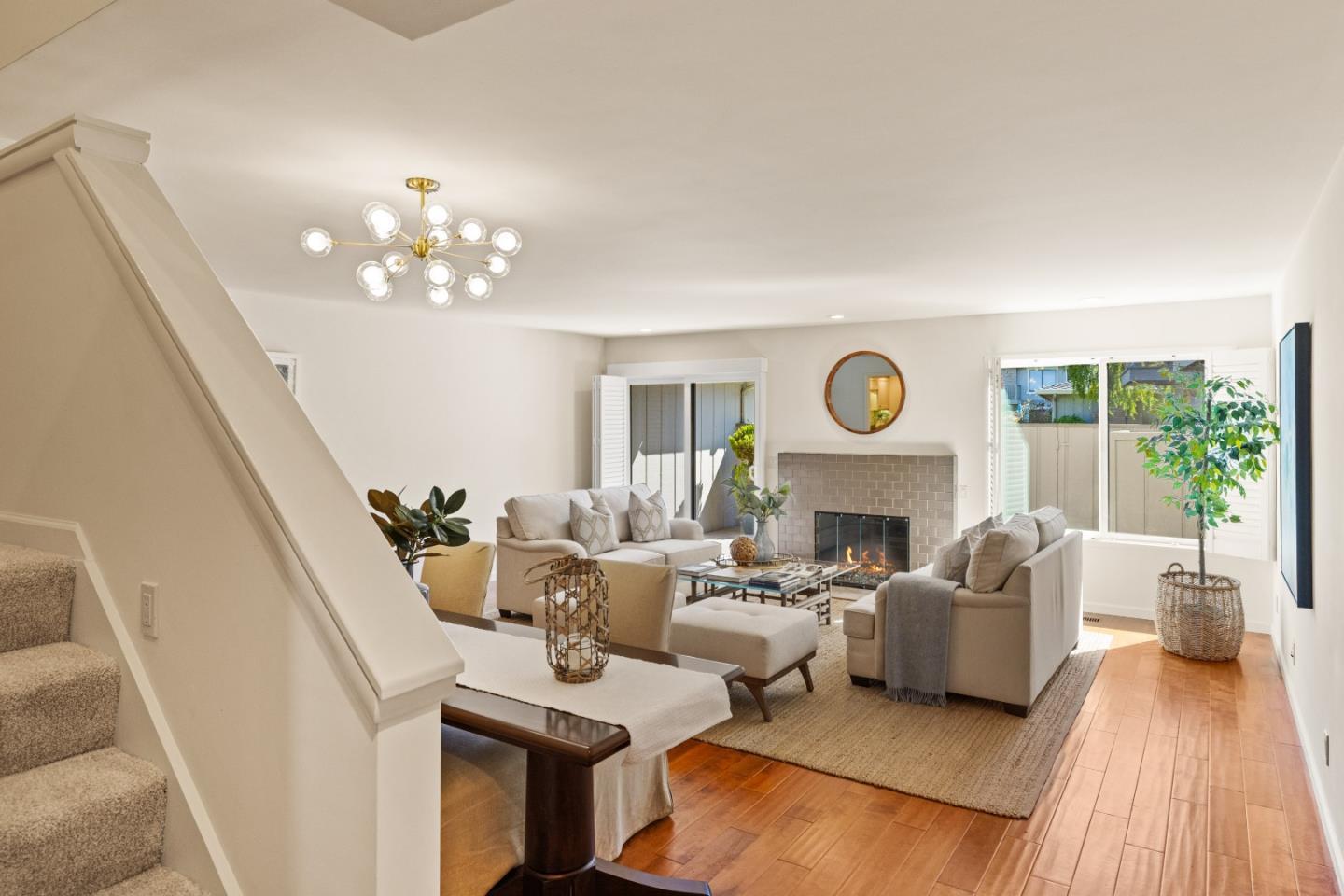 3850 Rio Road, Unit 61 Carmel, CA 93923 - Photo 2 of 46 a living room with fireplace furniture and a large window