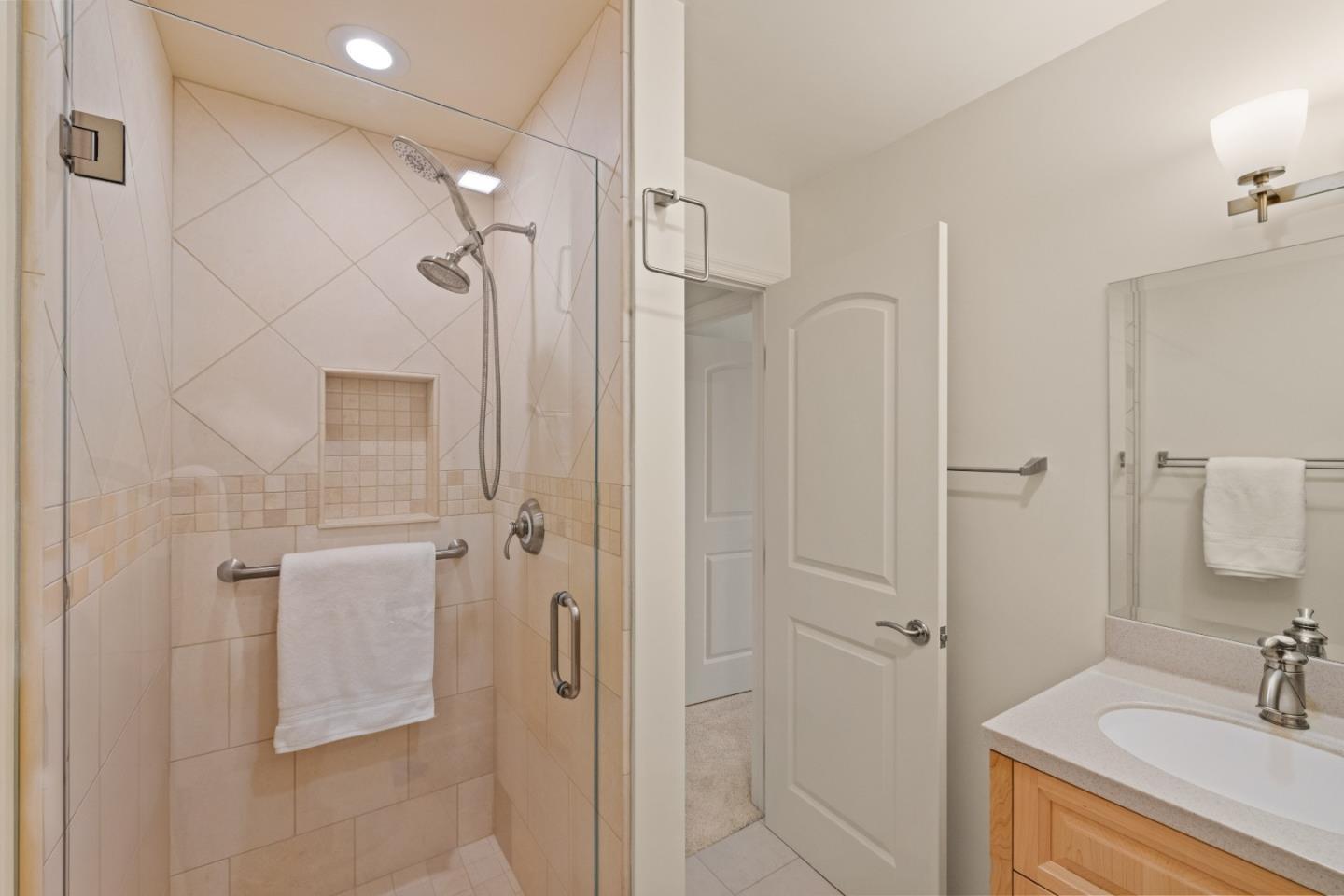 3850 Rio Road, Unit 61 Carmel, CA 93923 - Photo 28 of 46 a bathroom with a shower sink and mirror