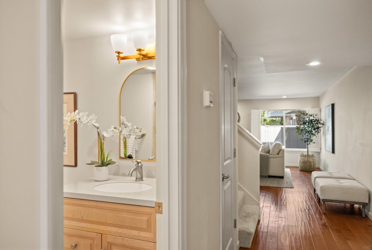 3850 Rio Road, Unit 61 Carmel, CA 93923 - Photo 31 of 46 a en suite bathroom with a granite countertop sink and a mirror