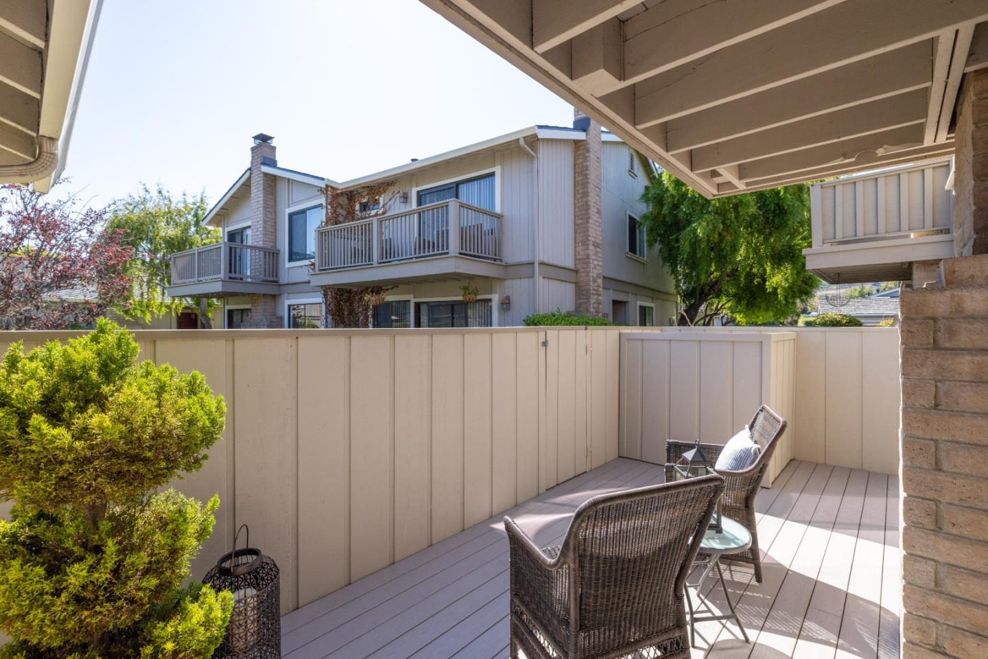 3850 Rio Road, Unit 61 Carmel, CA 93923 - Photo 34 of 46 a view of a patio with table and chairs and potted plants