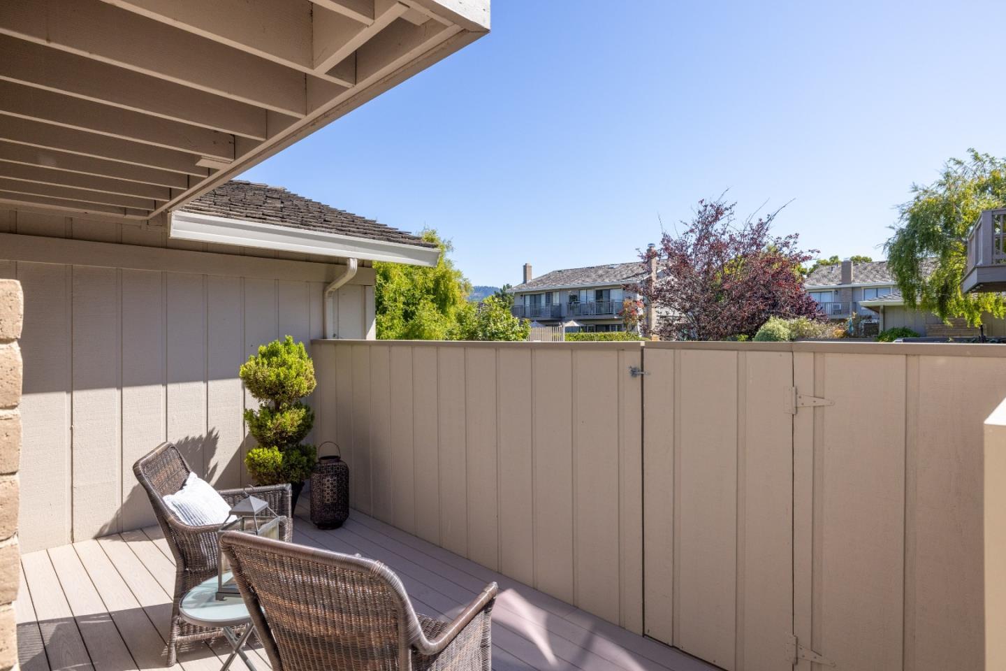 3850 Rio Road, Unit 61 Carmel, CA 93923 - Photo 36 of 46 a backyard of a house with table and chairs plants