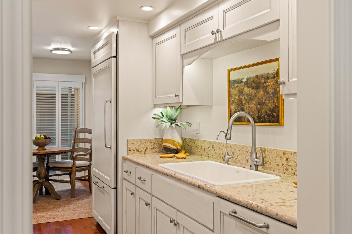 3850 Rio Road, Unit 61 Carmel, CA 93923 - Photo 7 of 46 a bathroom with a granite countertop sink a toilet and a mirror