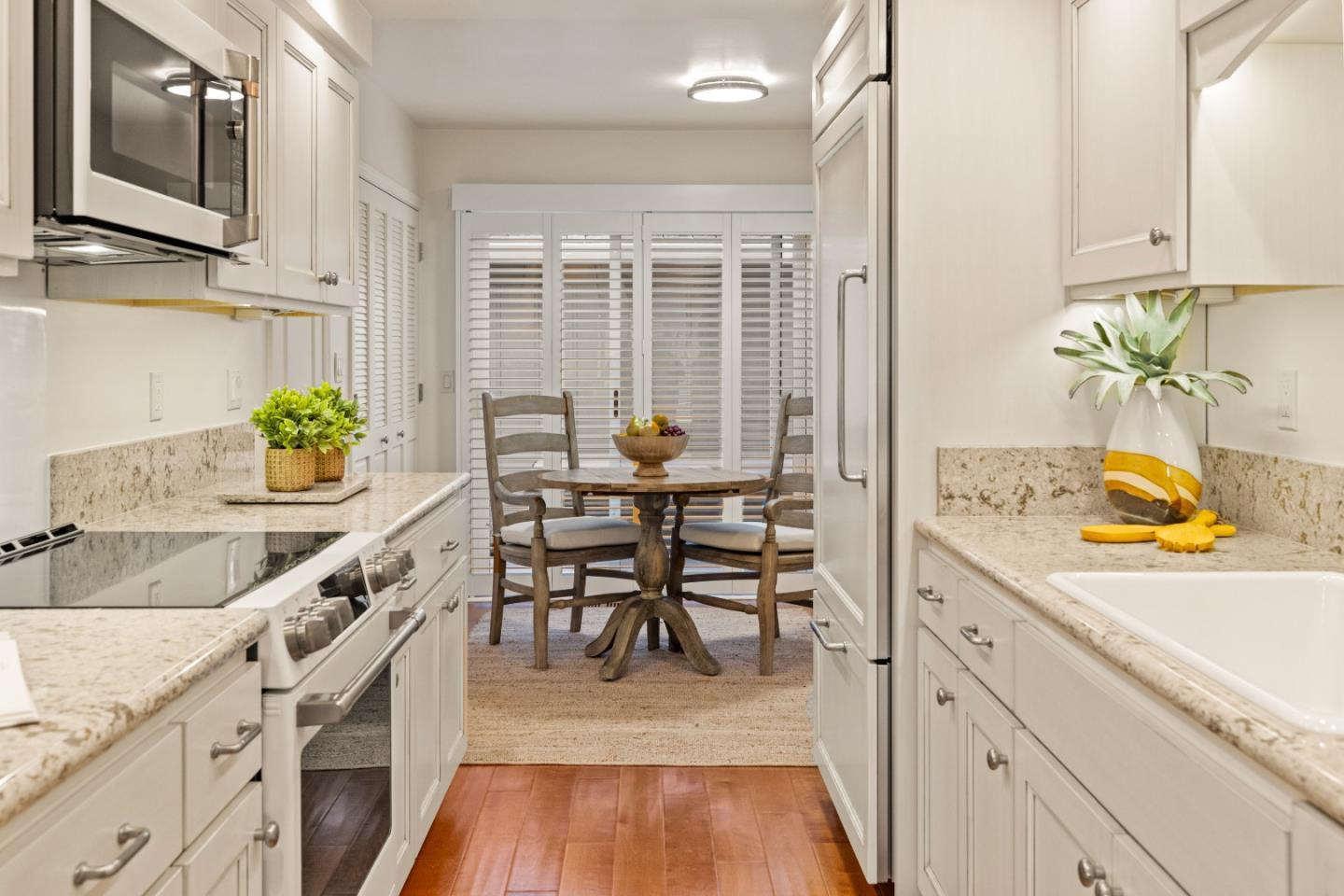 3850 Rio Road, Unit 61 Carmel, CA 93923 - Photo 8 of 46 a view of a kitchen with furniture and wooden floor
