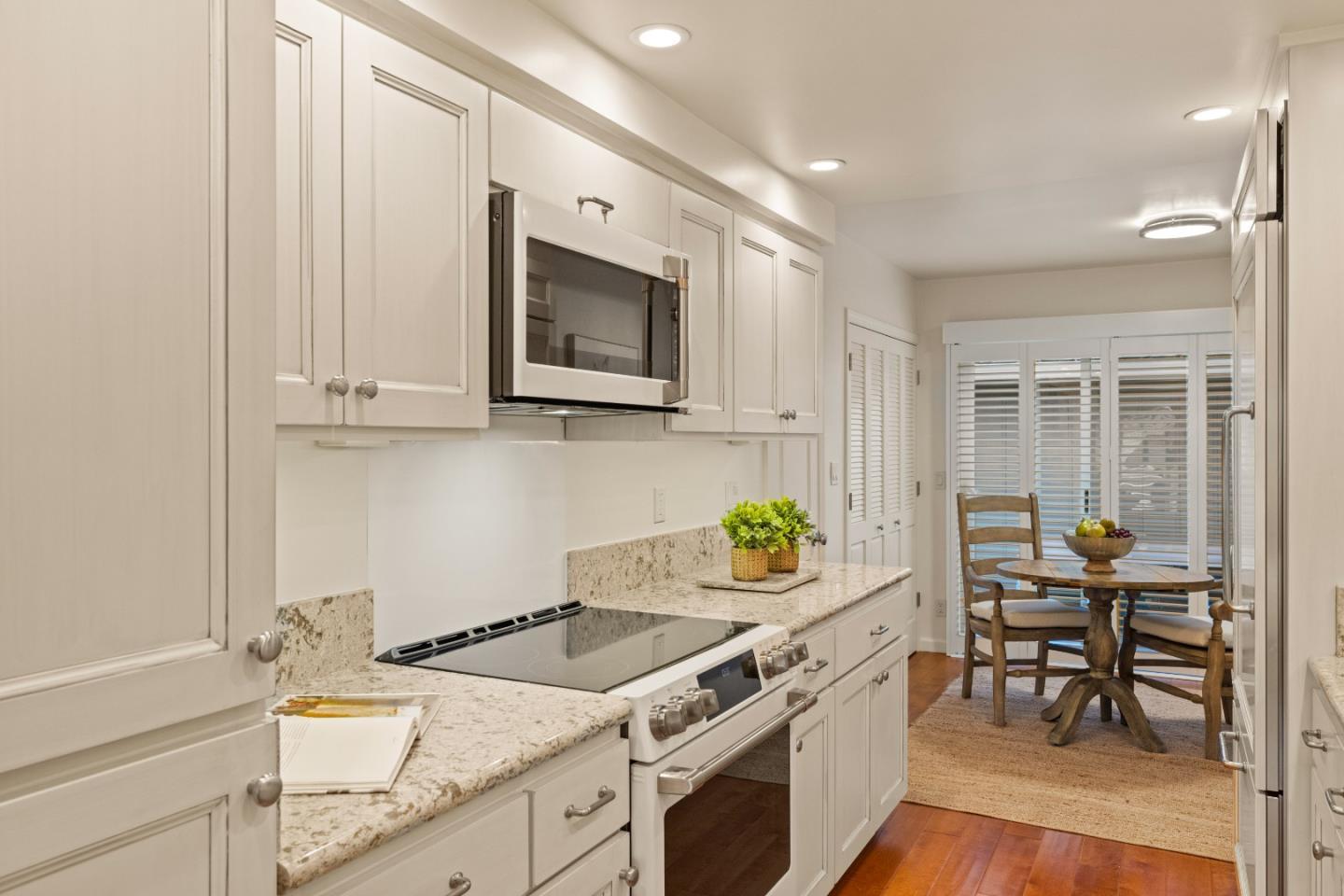 3850 Rio Road, Unit 61 Carmel, CA 93923 - Photo 9 of 46 a kitchen with a sink cabinets and window