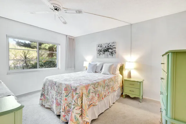 a spacious bedroom with a large bed and a chandelier
