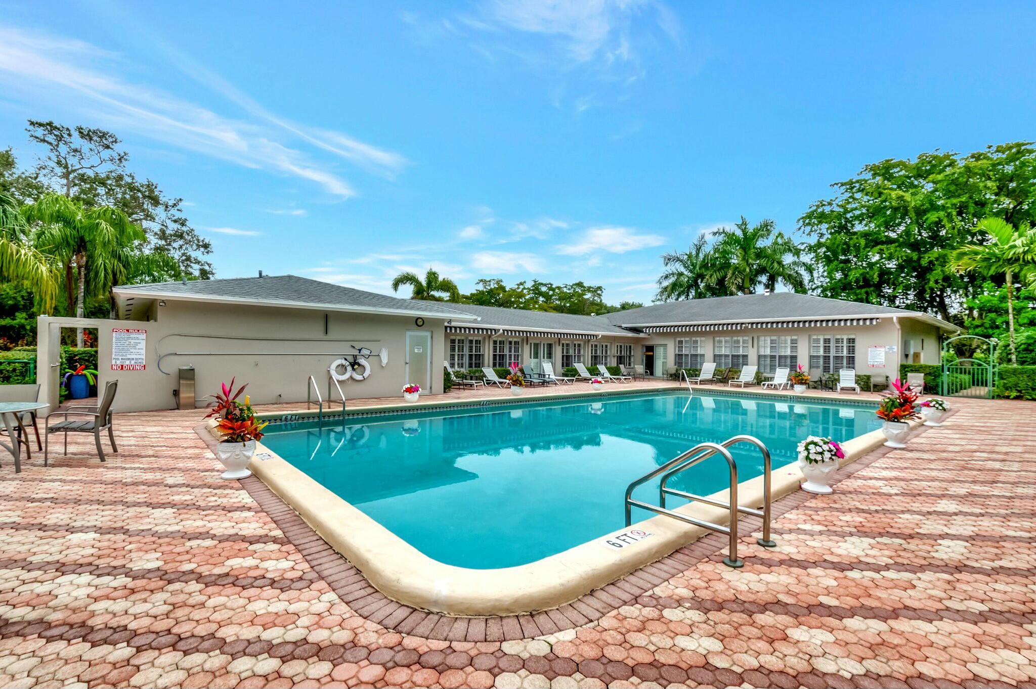 2320 Southwest 22nd Avenue, Unit 211 Delray Beach, FL 33445 - Photo 28 of 38 a view of a house with swimming pool