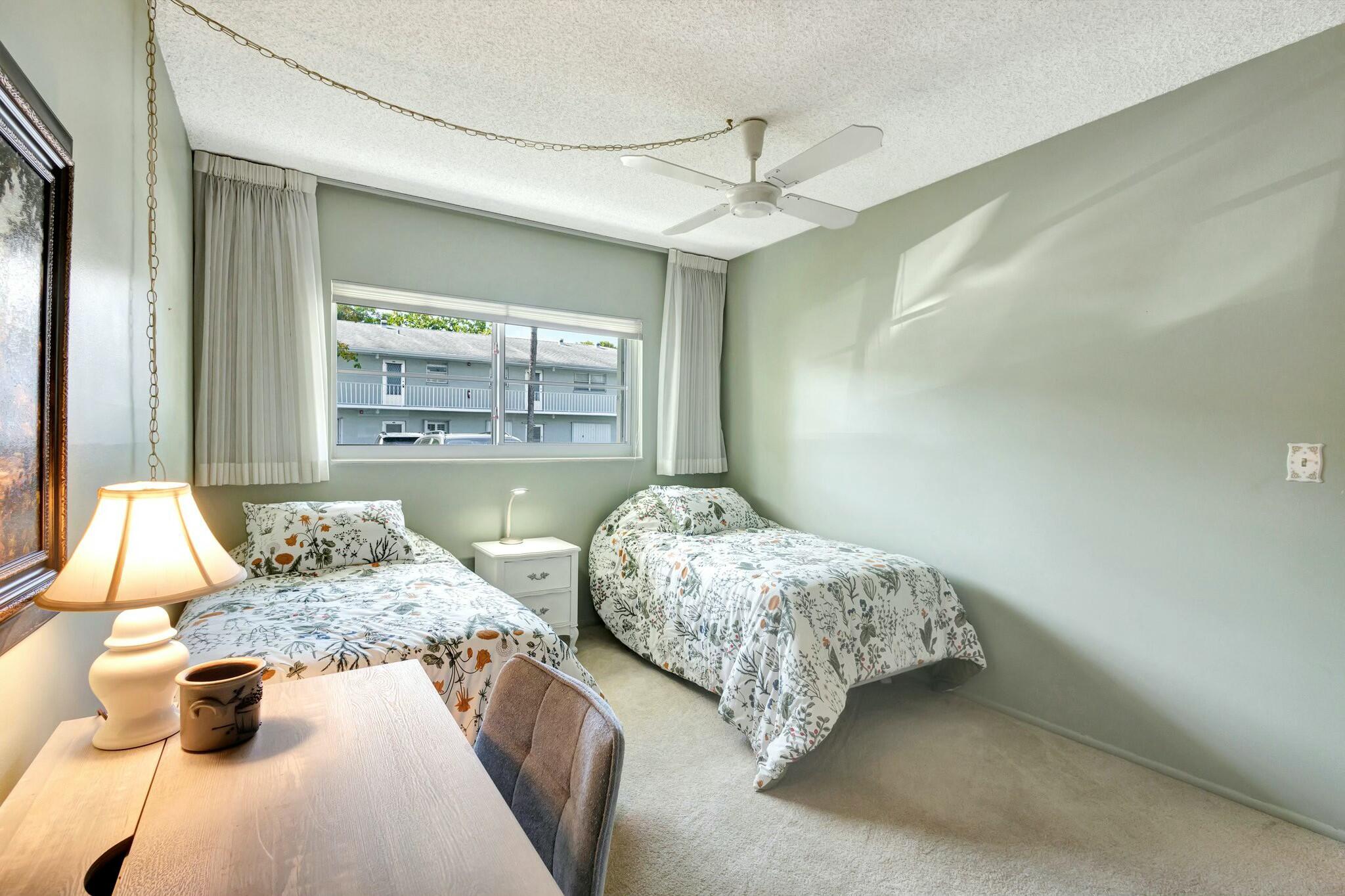 2320 Southwest 22nd Avenue, Unit 211 Delray Beach, FL 33445 - Photo 5 of 38 a bedroom with two beds and view of living room