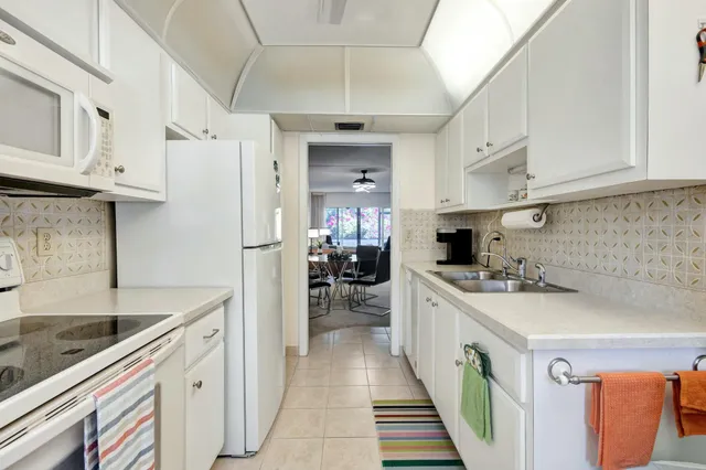 a kitchen with cabinets and stainless steel appliances